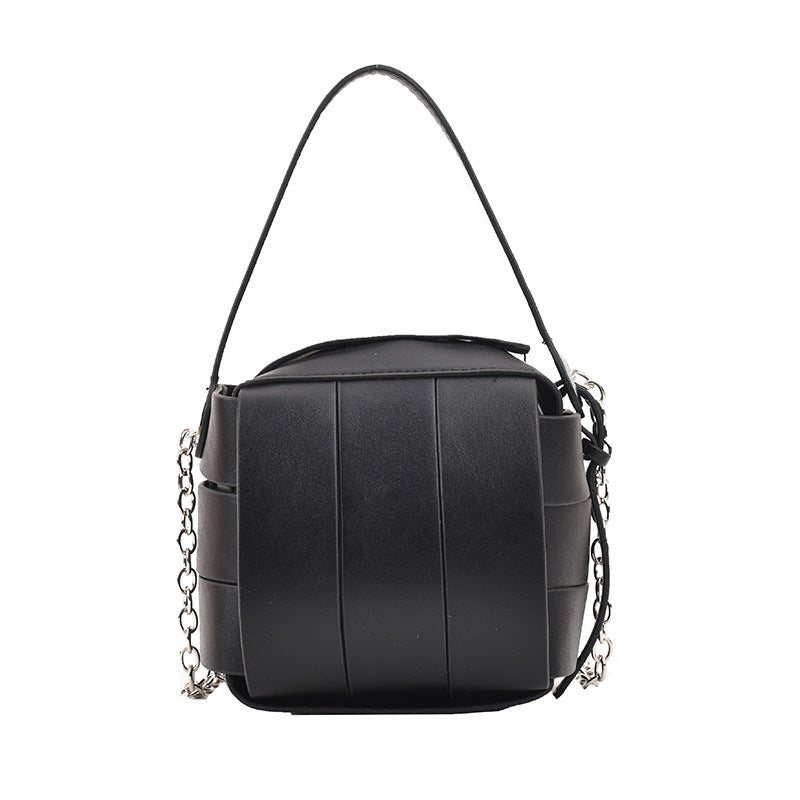 Black handbag with chain details on a white background