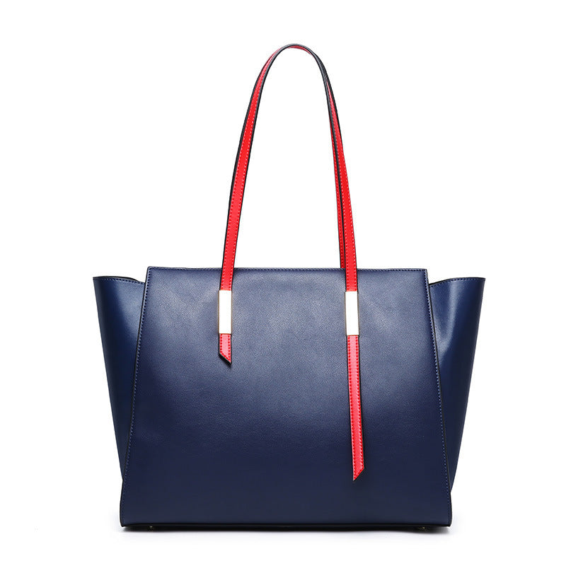 Blue handbag with red handles on a white background
