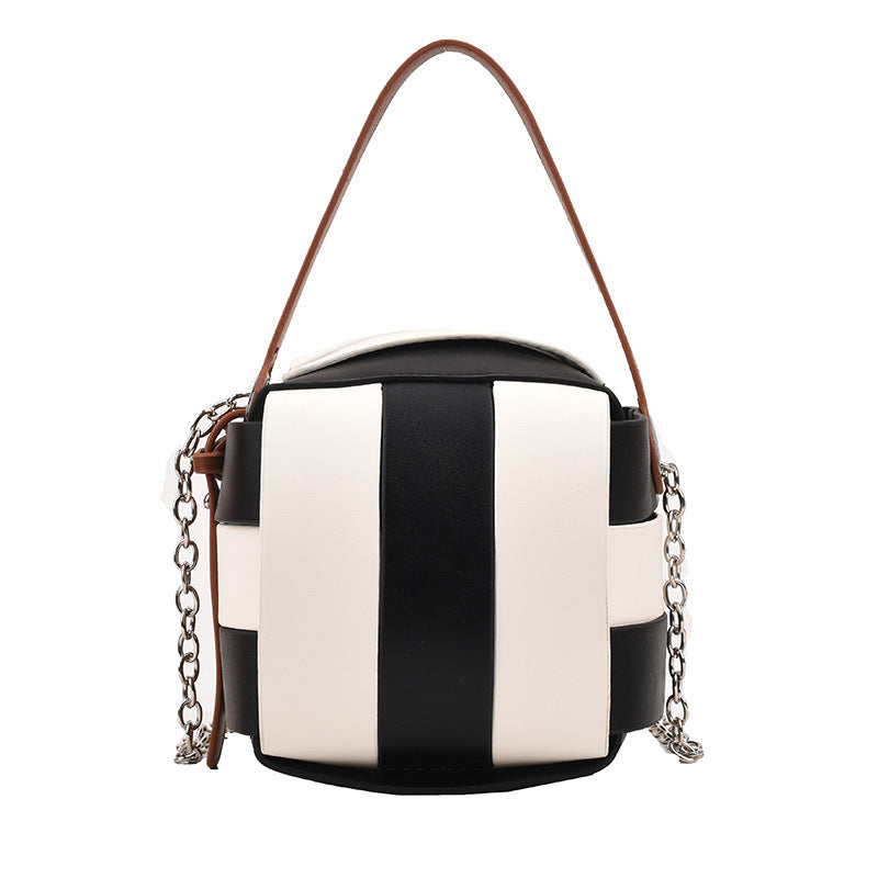 Black and white striped handbag with a chain detail on a white background