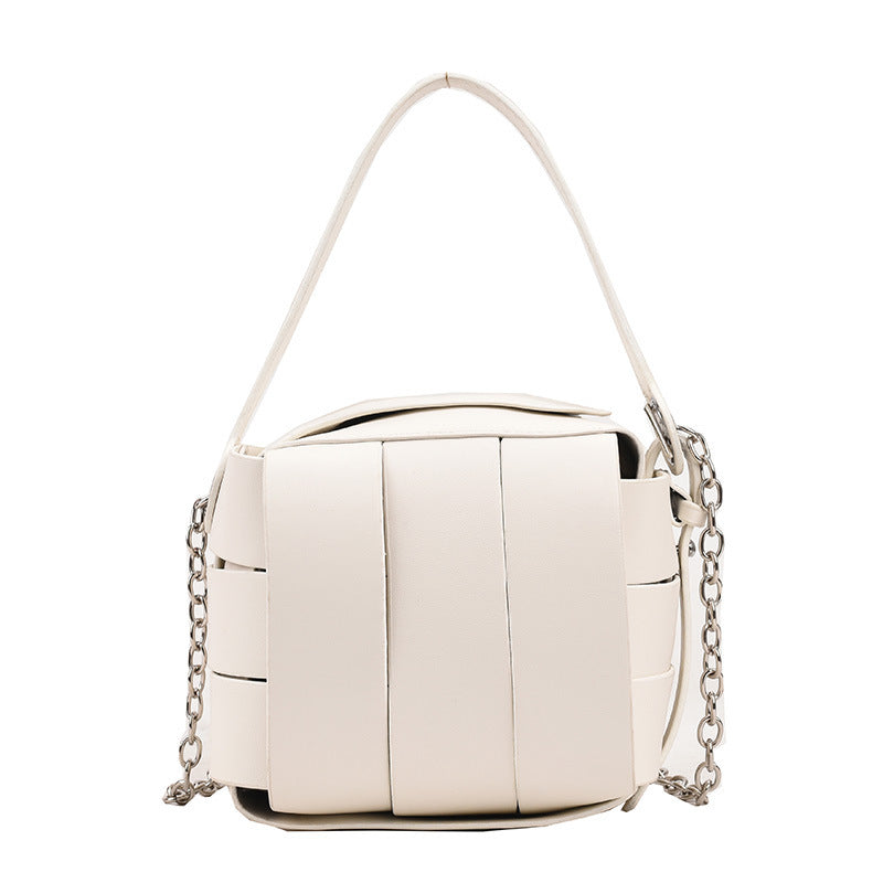 White handbag with chain details on a white background