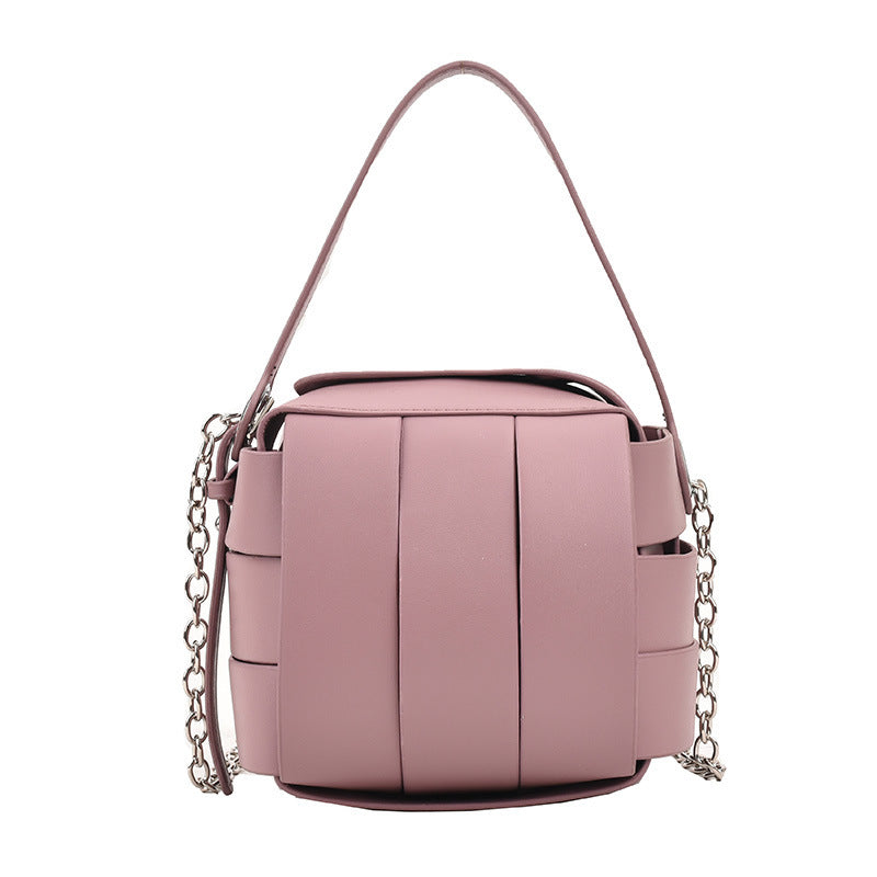 Pink handbag with chain detail on a white background